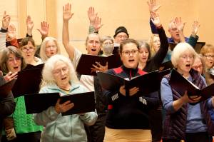 Choir members rehearse Tuesday night for a Bach holiday concert at Ḵunéix̱ Hídi Northern Light United Church. (Mark Sabbatini / Juneau Empire)