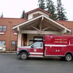 A Capital City Fire/Rescue truck parks outside the main entrance of the Riverview Senior Living complex Monday after Nathan Bishop, 58, is found alive in the attic 40 hours after being reported missing from the facility where he is a resident. (Mark Sabbatini / Juneau Empire)