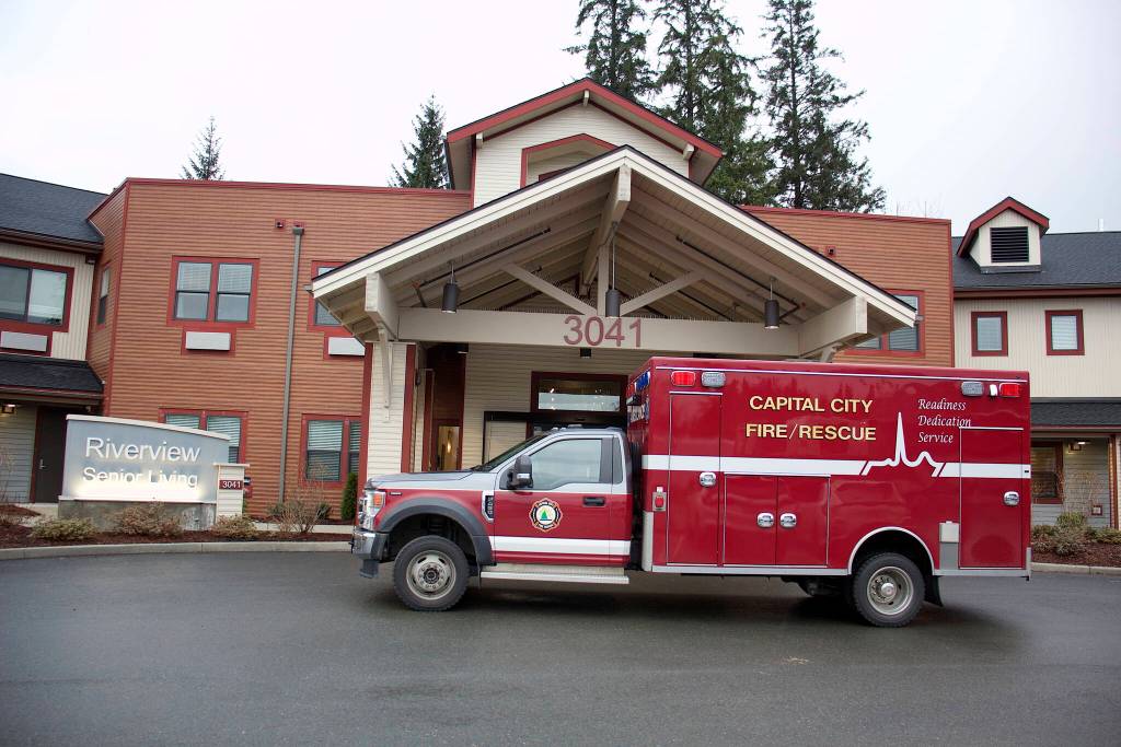 A Capital City Fire/Rescue truck parks outside the main entrance of the Riverview Senior Living complex Monday after Nathan Bishop, 58, is found alive in the attic 40 hours after being reported missing from the facility where he is a resident. (Mark Sabbatini / Juneau Empire)