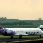 A Hawaiian Airlines plane taxis for position at Kahalui, Hawaii, on the island of Maui, March 24, 2005. Alaska Air Group said Sunday that it agreed to buy Hawaiian Airlines in a $1 billion deal. (AP Photo/Lucy Pemoni, File)