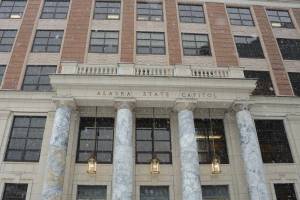 Snow falls on the Alaska State Capitol on Monday, Jan. 30, 2023. (Photo by James Brooks/Alaska Beacon)