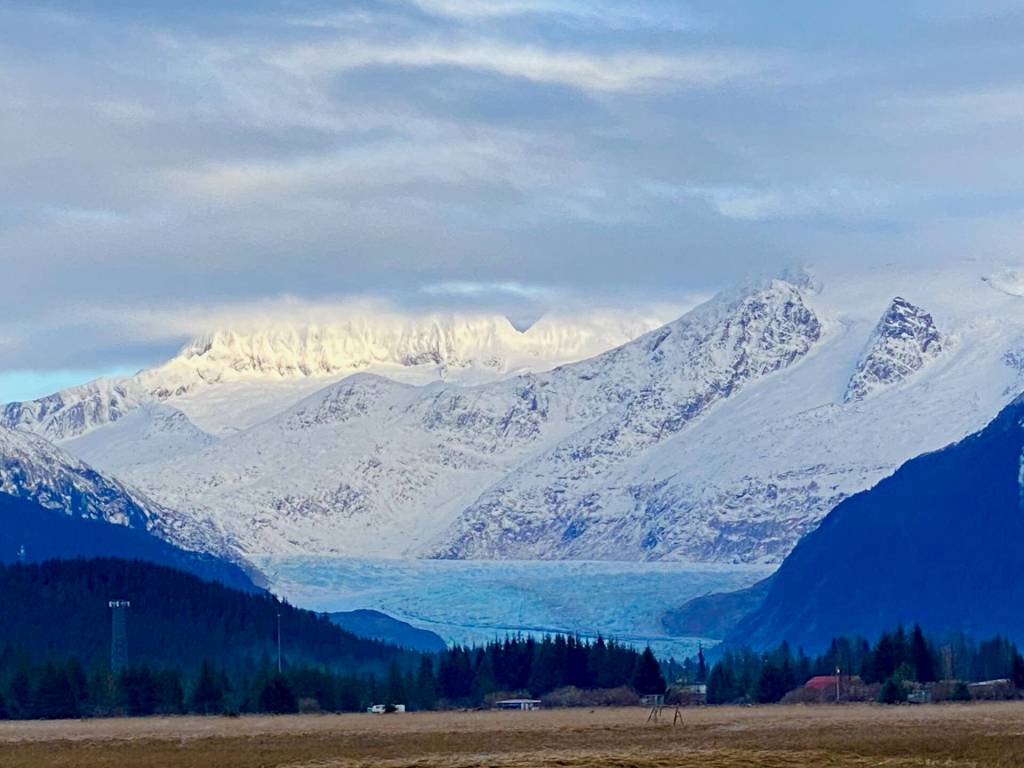 The snow-covered Mendenhall Towers rise above the blue Mendenhall Glacier on Dec. 2. (Photo by Denise Carroll)