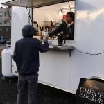 Larissa Dybdahl, an employee at the Crepe Escape food truck, hands a drunk to Brandon Elton at the new Vintage Food Truck Park on Wednesday. (Mark Sabbatini / Juneau Empire)
