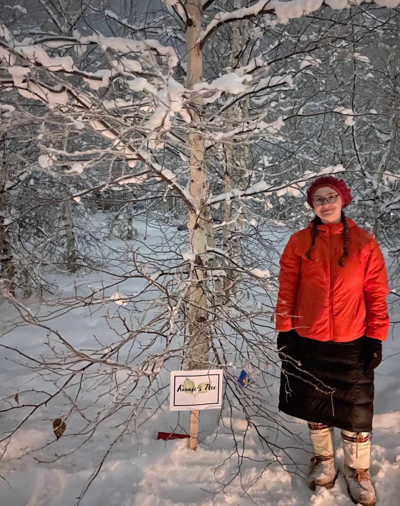 Annemarie Timling stands near a birch tree she helped choose to honor her father Ronnie Daanen, who died in a helicopter crash in July. (Photo by Ned Rozell)