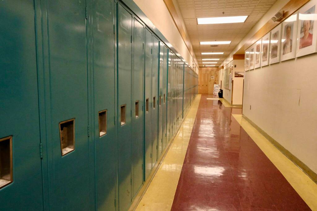 The halls are lined with lockers and portraits of elders at the Anna Tobeluk Memorial School in Nunapitchuk, on Oct. 12. (Photo by Claire Stremple / Alaska Beacon)
