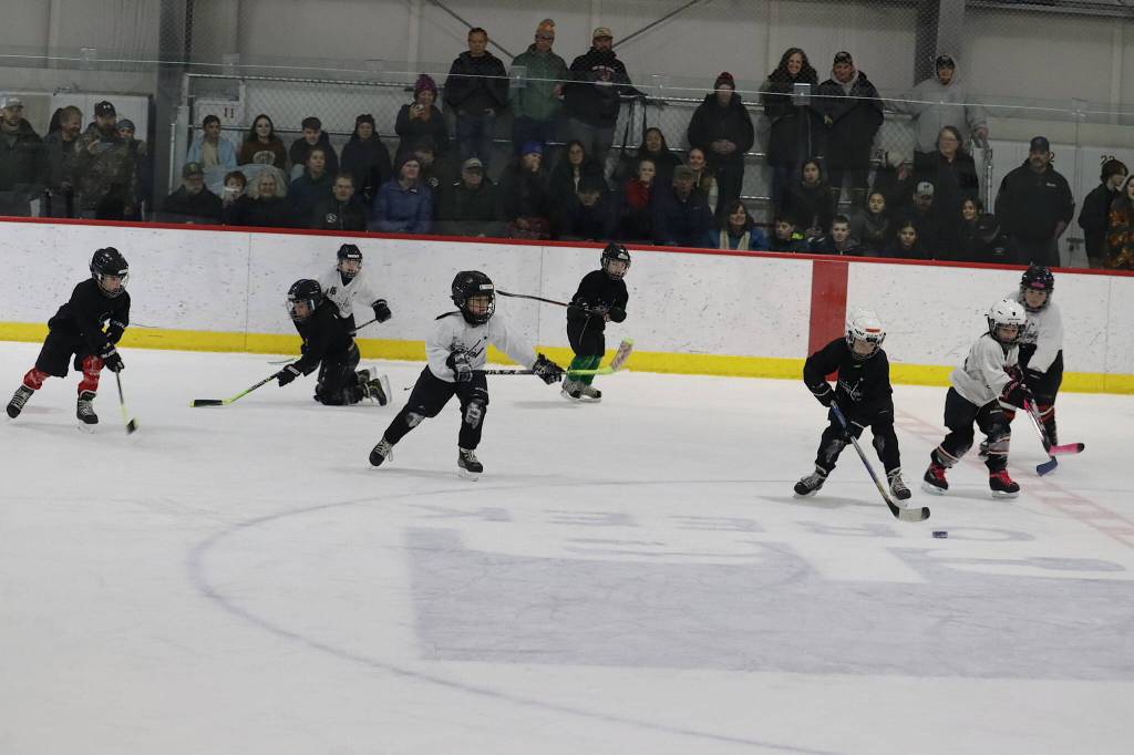 Youths face off in an abbreviated match between the first and second periods of Saturdays game between Juneau-Douglas High School: Yadaa.at Kalé and Kodiak High School at Treadwell Arena. (Mark Sabbatini / Juneau Empire)