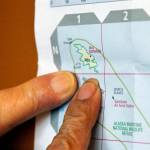 Pauline Golodoff and George Kudrin point to Attu Island, the most westerly in the Alaskas Aleutian Islands, on a map, Friday, Dec. 1, 2023, in Anchorage, Alaska. Their deceased spouses, Gregory Golodoff and Elizabeth Golodoff Kurduin, were the last two living residents of Attu, Alaska, whose entire population was captured by the Japanese during World War II and sent to Japan until being liberated after the war. The community of Attu was not rebuilt, and residents were resettled elsewhere, mostly in Atka, Alaska. (AP Photo/Mark Thiessen)