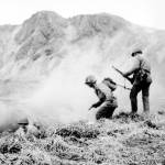 A U.S. squad armed with guns and hand grenades closes in on Japanese holdouts entrenched in dugouts during World War II on Attu Island, Alaska, in June 1943. Gregory Golodoff, who was 3 years old when his remote Alaska island was captured by Japanese troops and who became the last survivor among its 41 residents sent to Japan as prisoners, has died. The island of Attu in the Aleutian chain was one of just a few U.S. territories taken by enemy forces during the war, and the American effort to reclaim it amid frigid rain, dense fog and hurricane-force winds was the only battle of the war fought on North American soil. (U.S. Army via AP, File)