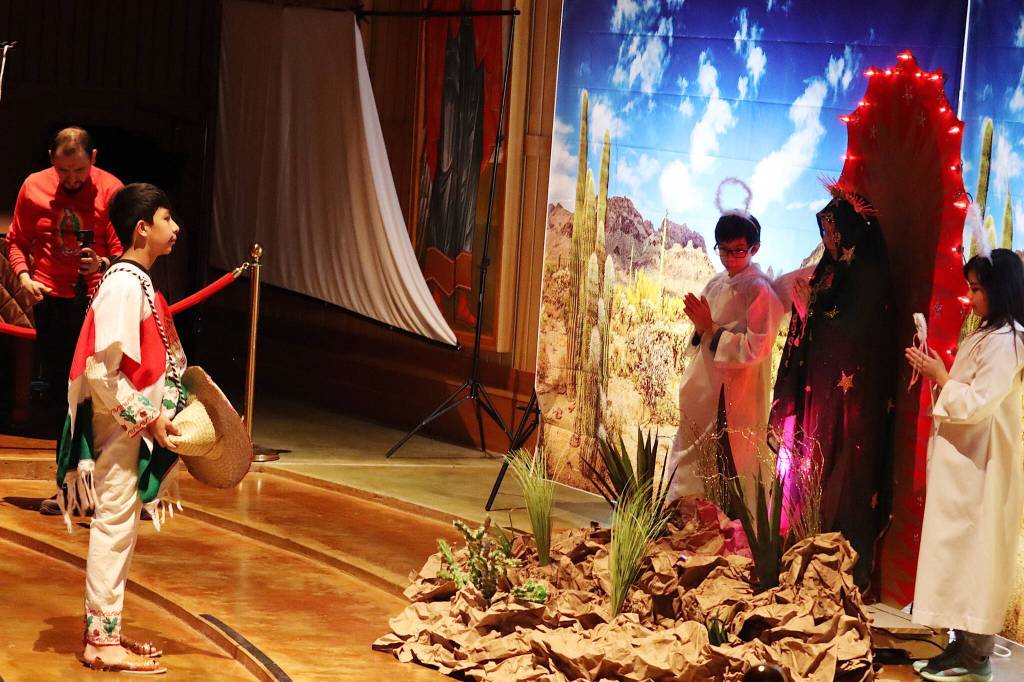 Imanol Vera (left), playing the lead character of Juan Diego, appears before the Virgin Mary (played by Kimberly Valadez) and angels (played by Milagros Correa and Carlos Orozco) during an Our Lady of Guadalupe play at St. Pauls Catholic Church on Sunday. (Mark Sabbatini / Juneau Empire)