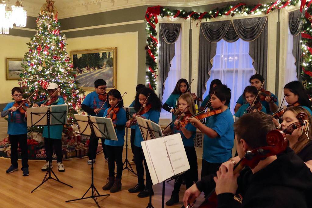 Students from the Juneau Alaska Music Matters program perform holiday songs during the annual Holiday Open House at the Governors Residence on Tuesday. (Mark Sabbatini / Juneau Empire)