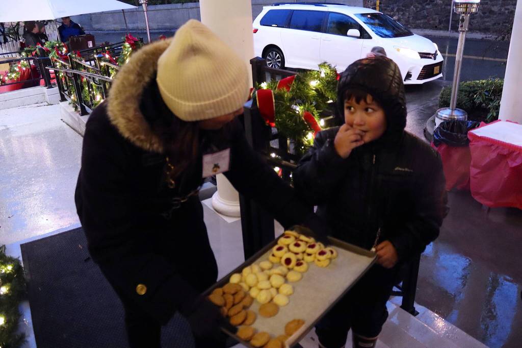Sawyer Jackson, 7, accepts a cookie from Julie Sande, commissioner of the Department of Commerce, Community and Economic Development, during the annual Holiday Open House at the Governors Residence on Tuesday. (Mark Sabbatini / Juneau Empire)