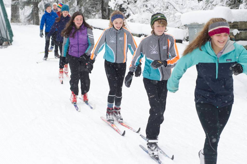 Juneau Nordic Ski Team members Erin Wallace, front, leads Aaron Blust and Anna Iverson in a pole-less skiing drill through fresh snow on Saturday, Nov. 18, 2017, at the Mendenhall Campgrounds. The team has been granted interim high school club status to compete in the Alaska School Activities Associations state championship for the first time in many years in February. (Nolin Ainsworth / Juneau Empire file photo)