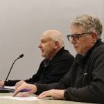 Steve Soenksen (left), with the private development group Gastineau Lodge Apartments LLC, and James Bibb, an architect on the project, discuss the proposal with the Juneau Planning Commission on Tuesday night. (Mark Sabbatini / Juneau Empire)