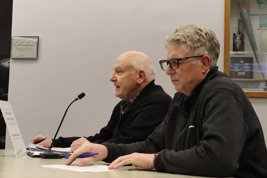 Steve Soenksen (left), with the private development group Gastineau Lodge Apartments LLC, and James Bibb, an architect on the project, discuss the proposal with the Juneau Planning Commission on Tuesday night. (Mark Sabbatini / Juneau Empire)
