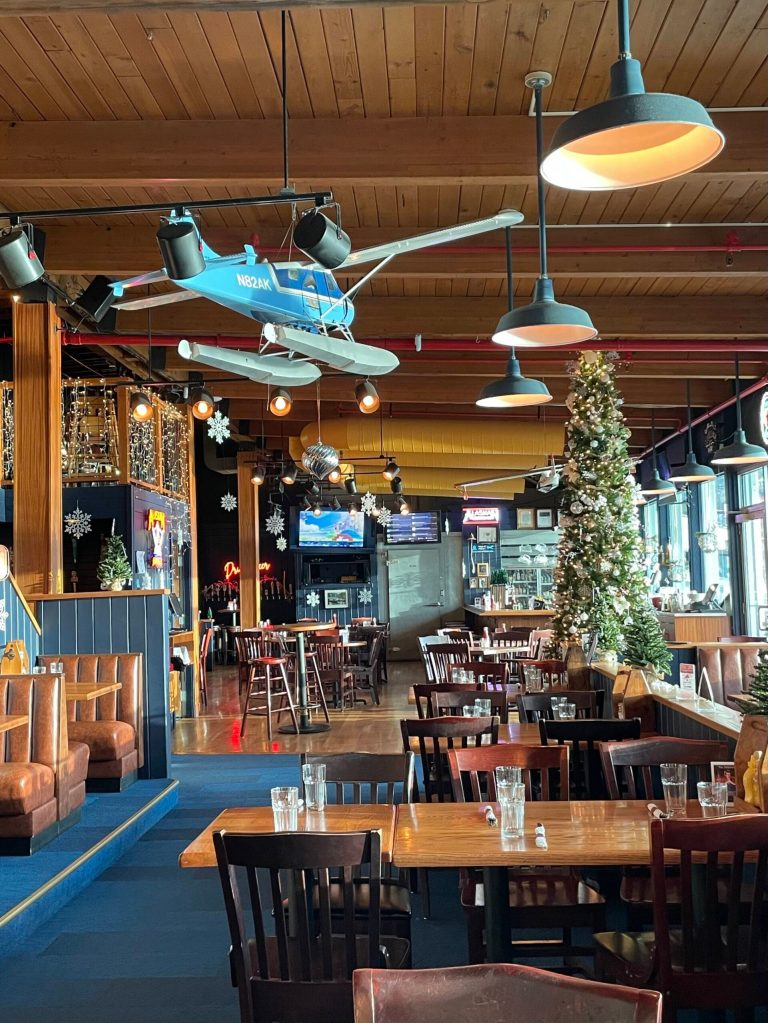 Hangar on the Wharfs interior is decorated for the holidays in this December 2023 photo showing large floatplane models suspended from the rafters. (Photo Laurie Craig)
