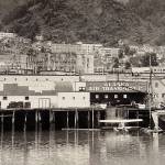 Alaska Air Transport hangar on the pilings dock and Marine Airways on the floating dock kept Juneaus waterfront busy with planes in this undated photo. It is likely taken after 1939 due to the black burn scars on the five-story concrete Goldstein Building exterior in the background. (Photo by Johnston, #1276, Jarman Collection P337)