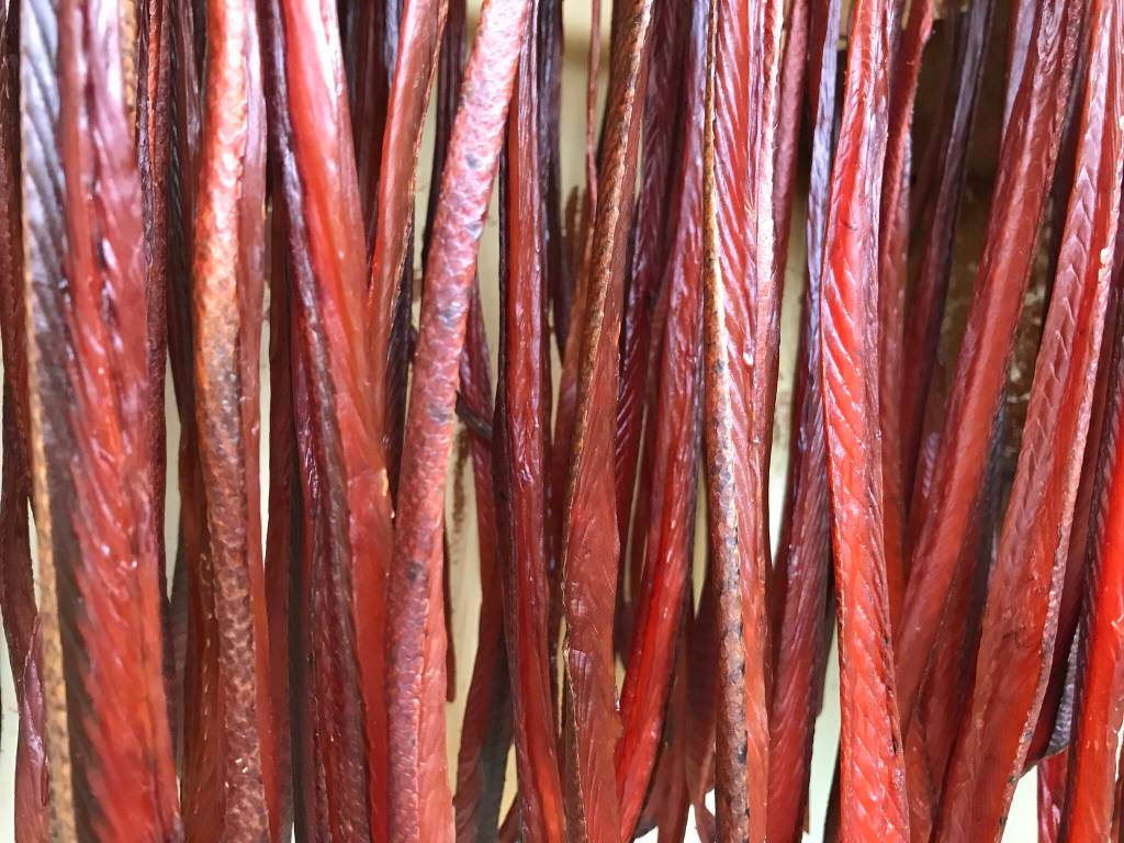 Strips from Tanana king salmon dry in a smokehouse in July 2019. (Photo by Sam Bishop)