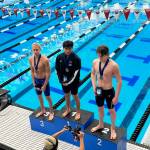 PJ Foy (right) stands on the podium after winning second place in the 100-yard fly during the Speedo Winter Junior Championships in Westmont, Illinois. (Kevin Tuning / Forever Still Photography)