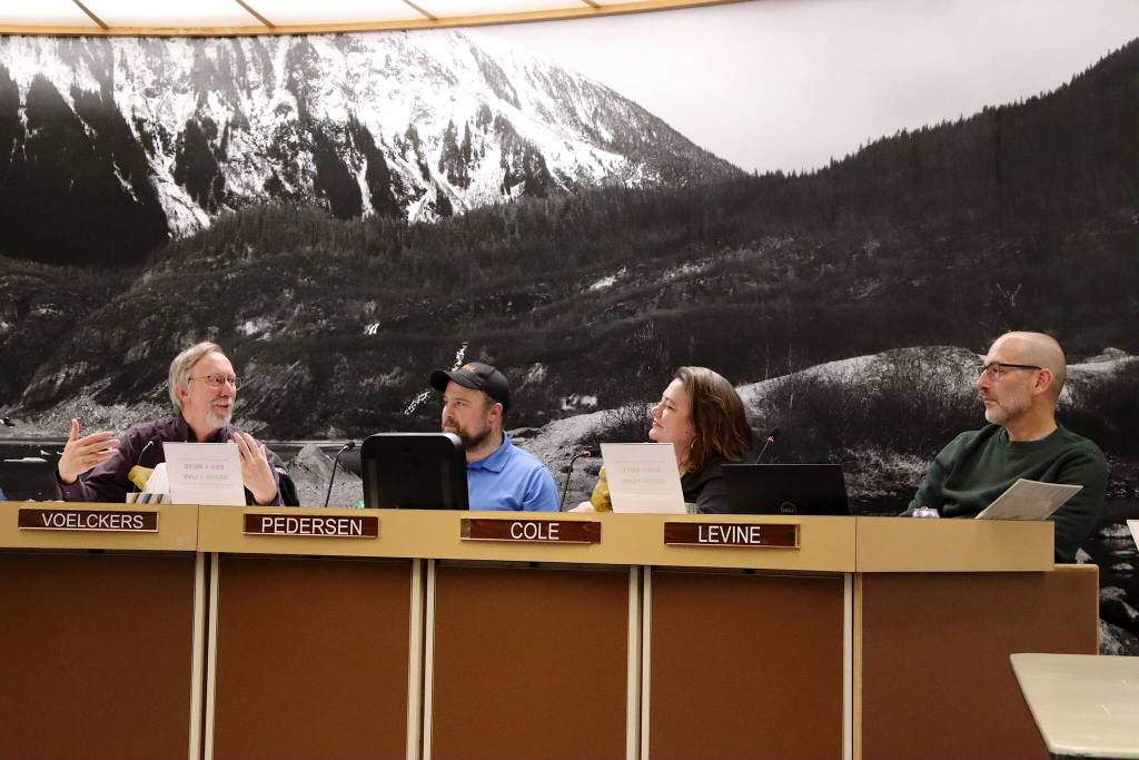 Paul Voelckers (left) offers farewell remarks along with Michael LeVine (right) during their last Juneau Planning Commission meeting Tuesday night. Listening to their remarks are commission members Mandy Cole  who was appointed to the board Thursday  and Erik Pedersen. (Mark Sabbatini / Juneau Empire)