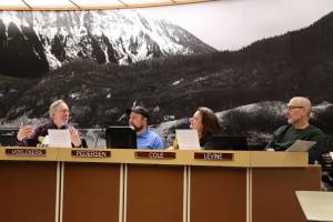 Paul Voelckers (left) offers farewell remarks along with Michael LeVine (right) during their last Juneau Planning Commission meeting Tuesday night. Listening to their remarks are commission members Mandy Cole  who was appointed to the board Thursday  and Erik Pedersen. (Mark Sabbatini / Juneau Empire)