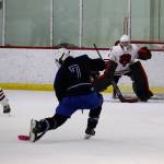 Palmer High Schools Ryan Martin (#2) looks to take a shot against Juneau-Douglas High School: Yadaa.at Kalé goalie Caleb Friend during Saturday nights game at Treadwell Arena. (Mark Sabbatini / Juneau Empire)