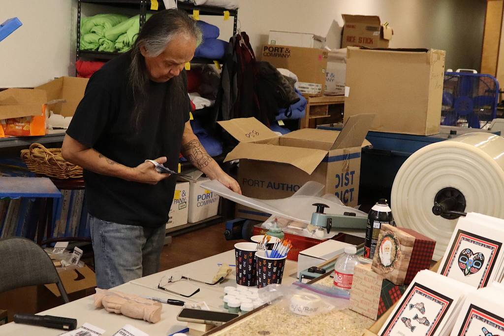 Everett Wright, an employee at Indigenous Art Doug Chilton Designs, packages paint-it-yourself totem pole kits at the store on Monday. (Mark Sabbatini / Juneau Empire)