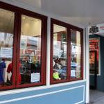 Signs in the windows of Indigenous Art Doug Chilton Designs on Monday advertise 50% off most items in the store before its scheduled closing on Sunday. (Mark Sabbatini / Juneau Empire)