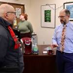 John Roxburgh (left) discusses his wish list for the upcoming legislative session with state Sen. Jesse Kiehl, a Juneau Democrat, during the annual holiday open house hosted by the local legislative delegation at the Alaska State Capitol on Tuesday. (Mark Sabbatini / Juneau Empire)