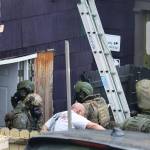 A man who refused orders to come out of a downtown residence for nearly three hours is taken into custody shortly after 1 p.m. Thursday. (Mark Sabbatini / Juneau Empire)