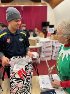 Volunteers prepare hundreds of bags of holiday food for The Salvation Army Juneau Corps annual Christmas distribution Dec. 16, with about 350 families in Juneau receiving food and gifts. (Photo by Gina Halverson / Salvation Army Juneau Corps)