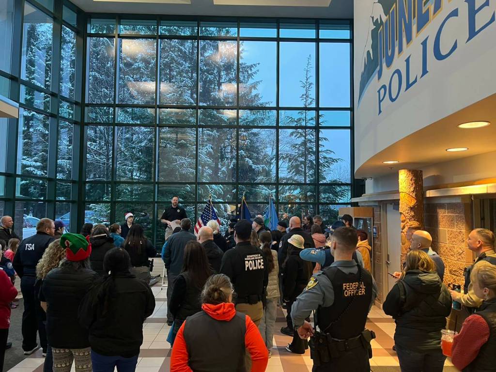 Dozens of police officers and volunteer elves gather at the Juneau Police Department station on Dec. 9 for a briefing before taking about 50 local children out for the annual Shop with a Cop organized by the Capital City Chapter of Alaska Peace Officers Association. (Photo courtesy of the Juneau Police Department)