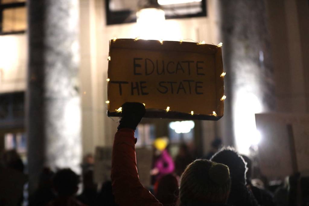 A protester holds a sign advocating for an increase in the states Base Student Allocation during a rally at the steps of the Alaska State Capitol on Monday, Jan. 23. (Clarise Larson / Juneau Empire file photo)