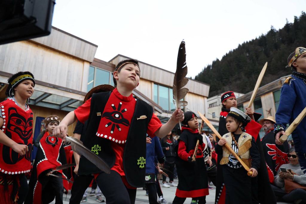 Students from the Tlingit Culture, Language and Literacy program at Harborview Elementary dance during the procession of the dedication ceremony of the Kootéeyaa Deiyí, Totem Pole Trail, held Saturday, April 22, in downtown Juneau at Heritage Plaza. (Clarise Larson / Juneau Empire file photo)