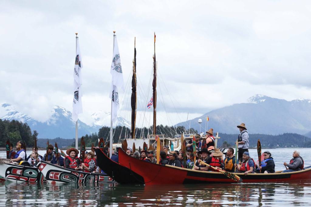 Crew members of the Moananuiākea voyage from the Hōkūlea canoe paddle to the shore of Auke Bay as they are welcomed Saturday, June 10, by Juneau residents and tribal leaders. (Clarise Larson / Juneau Empire file photo)