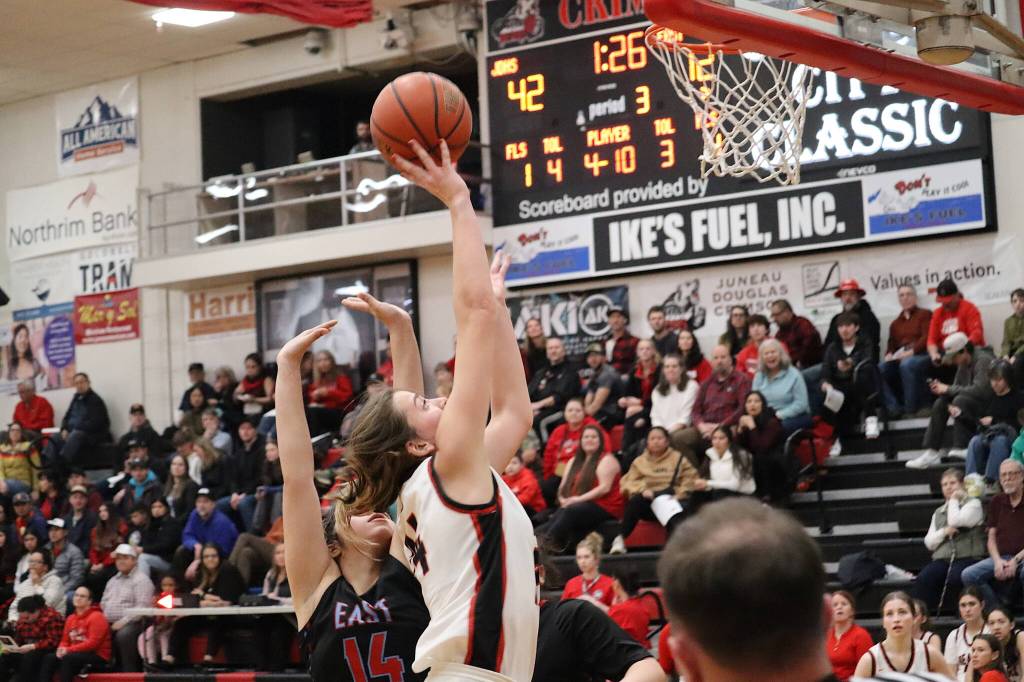 Mila Hargrave of Juneau-Douglas High School: Yadaa.at Kalé goes up for a shot against Dayzia Gonzalez-Velazquez of Bettye Davis East Anchorage High School during their Capital City Classic matchup Wednesday night at JDHS. (Mark Sabbatini / Juneau Empire)