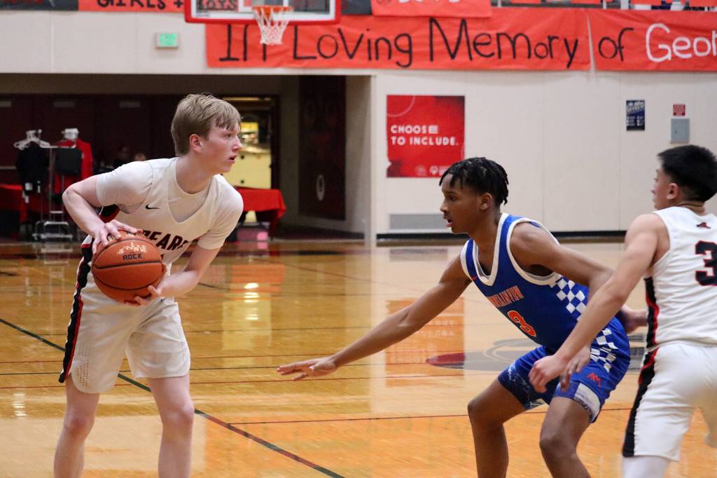 Sean Oliver of Juneau-Douglas High School: Yadaa.at Kalé looks to drive the ball against Sebastian Arius of Auburn Mountainview High School during their Capital City Classic game Wednesday night at JDHS. (Mark Sabbatini / Juneau Empire)