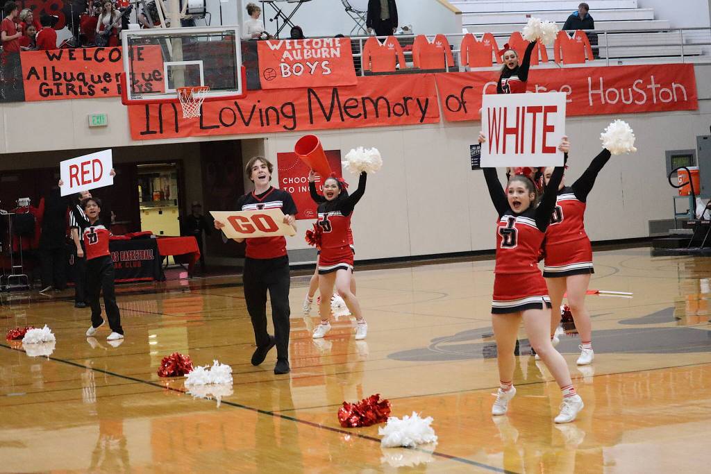 The Juneau-Douglas High School: Yadaa.at Kalé cheer team performs a routine during a timeout at the Capital City Classic on Wednesday in the newly renamed George Houston Gymnasium, in honor of the longtime former JDHS basketball coach who died earlier this year. A banner, photos and other items honoring him were displayed in the gym during the evening, which also featured a tribute to him by current JDHS basketball coach Robert Casperson. (Mark Sabbatini / Juneau Empire)