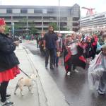 Mary Snook, a Ketchikan resident of Tlingit, Haida and Tsimshian ancestry, takes a photo of her fellow Alaska Natives passing by during the Celebration parade in downtown Juneau on Saturday, June 11, 2022. In the background is one of the large cruise ships docked in town for the day. (Mark Sabbatini / Juneau Empire file photo)