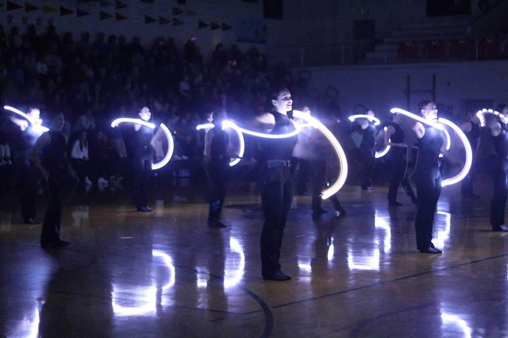 The Juneau-Douglas High School: Yadaa.at Kalé Dance Team performs a light show during halftime of the boys game between JDHS and Albuquerque High School on Saturday at JDHS. (Mark Sabbatini / Juneau Empire)