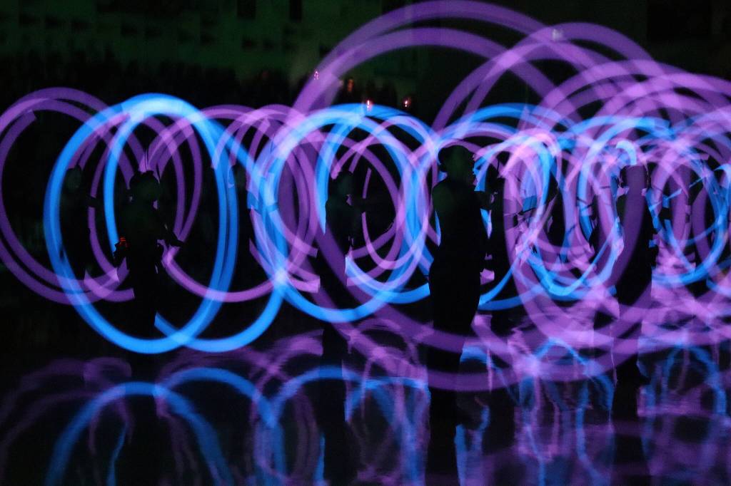 The Juneau-Douglas High School: Yadaa.at Kalé Dance Team performs a light show during halftime of the boys game between JDHS and Albuquerque High School on Saturday at JDHS. (Mark Sabbatini / Juneau Empire)