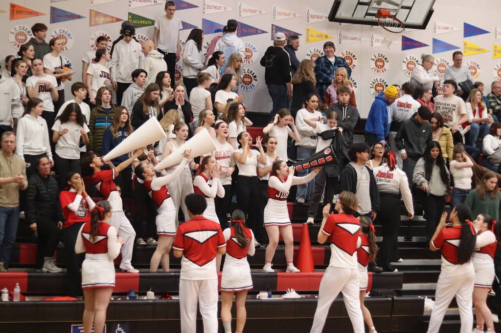 The Juneau-Douglas High School: Yadaa.at Kalé Cheer Team and other Crimson Bear supporters offer their support to the boys team during the final game of the Capital City Classic on Saturday at JDHS. (Mark Sabbatini / Juneau Empire)