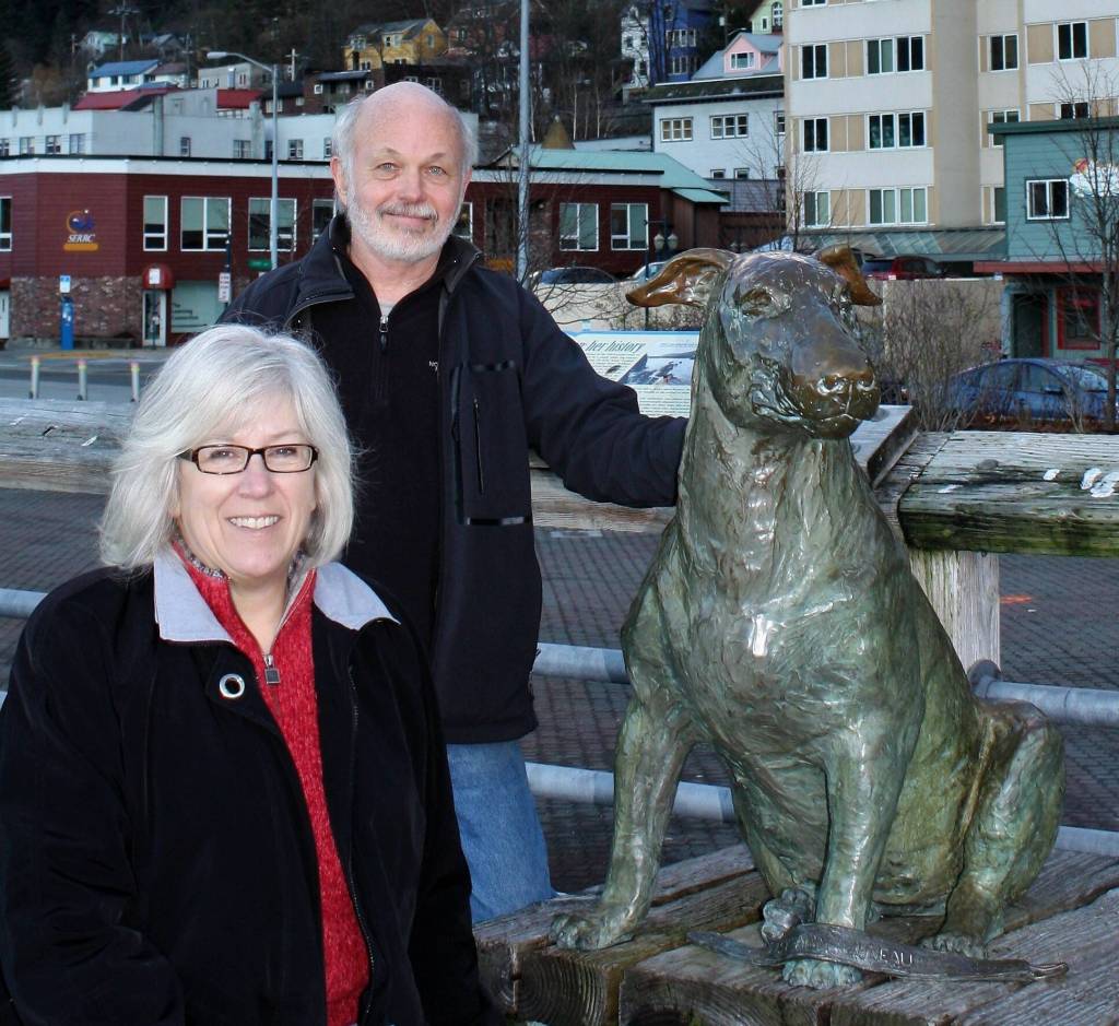 Author Tricia Brown and illustrator Jim Fowler are seen by the Patsy Ann statue on the downtown cruse ship dock in a photo published in the new version of their book Patsy Ann of Alaska scheduled for re-release Jan. 9. (Photo courtesy of Tricia Brown)