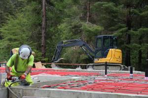 A worker uses machinery while working on the construction site of Central Council of Tlingit and Haida Indian Tribes of Alaskas revived Haven House on July 31, 2023. (Clarise Larson / Juneau Empire file photo)