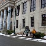 An employee leaves the Alaska State Capitol on Wednesday, March 15, 2023. The building was among numerous state capitals targeted by bomb threats that federal law enforcement officials are calling a hoax. (Mark Sabbatini / Juneau Empire file photo)