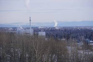 Smokestack emissions are seen along the Fairbanks skyline on March 1, 2023. At left is the coal-fired heat and power plant on the University of Alaska Fairbanks campus. (Yereth Rosen/Alaska Beacon)