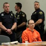 Surrounded by officers, Green River Killer Gary Ridgway sits in court during his arraignment on charges of murder in the 1982 death of Rebecca Becky Marrero, Friday, Feb. 18, 2011, at the King County Regional Justice Center in Kent., Wash. Ridgway pleaded guilty Friday to the killing, and was spared the death penalty as part of a 2003 plea deal. (AP Photo/Elaine Thompson)