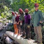 Participants in the 2023 VetsWork AmeriCorps interns program stand on a bridge they built in 2023. (Photo courtesy of the Mt. Adams Institute)