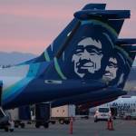 Alaska Airlines planes are shown parked at gates at sunrise, March 1, 2021, at Seattle-Tacoma International Airport in Seattle. An Alaska Airlines flight made an emergency landing in Oregon on Friday after a window and chunk of its fuselage blew out in mid-air, media reports said. (AP Photo/Ted S. Warren, File)