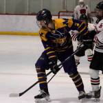 Homer High Schools Seamus Hatton (#3) tries to get the puck past Juneau-Douglas High School: Yadaa.at Kalé players during Saturdays game at Treadwell Arena. (Mark Sabbatini / Juneau Empire)