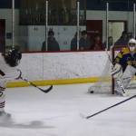 Juneau-Douglas High School: Yadaa.at Kalés Caden Morris (#15) takes a successful shot to make the score 3-0 against Homer High School during the first period of their game Saturday at Treadwell Arena. (Mark Sabbatini / Juneau Empire)